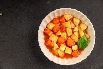 Stewed potatoes with carrots vegetarian side dish fresh delicious gourmet food background on the...