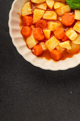 Stewed potatoes with carrots vegetarian side dish fresh delicious gourmet food background on the table rustic food top view copy space keto and paleo diet vegan food