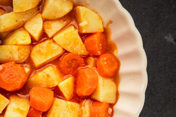 Stewed potatoes with carrots vegetarian side dish fresh delicious gourmet food background on the table rustic food top view copy space keto and paleo diet vegan food