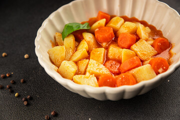Stewed potatoes with carrots vegetarian side dish fresh delicious gourmet food background on the table rustic food top view copy space keto and paleo diet vegan food