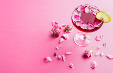 Cocktail bar background. Rose beverage with vodka, pineapple juice and strawberry champagne served...