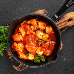 Butter chicken curry poultry meat tomato sauce dish fresh tasty gourmet food background on the table rustic food top view copy space