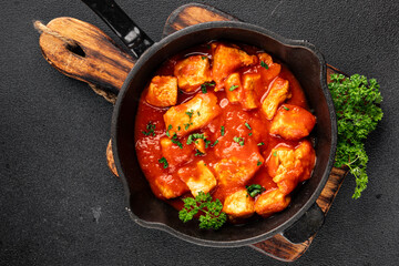 Butter chicken curry poultry meat tomato sauce dish fresh tasty gourmet food background on the table rustic food top view copy space