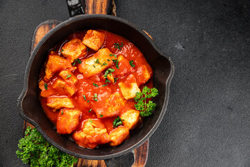 Butter chicken curry poultry meat tomato sauce dish fresh tasty gourmet food background on the table rustic food top view copy space
