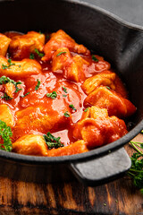 Butter chicken curry poultry meat tomato sauce dish fresh tasty gourmet food background on the table rustic food top view copy space