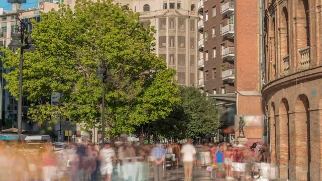 Timelapse of the Bullring of Valencia (Plaza de Bous) and Bullfighting Museum, near Nord station. People walking around the historic amphitheater with a blue sky backdrop. Valencia, Spain.