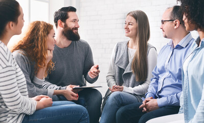 Professional help. Psychotherapist talking with patients during support group meeting, panorama