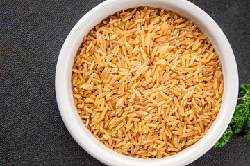 Brown rice whole grain cereal healthy product superfood fresh tasty gourmet food background on the table rustic food top view copy space keto and paleo diet vegetarian and vegan food