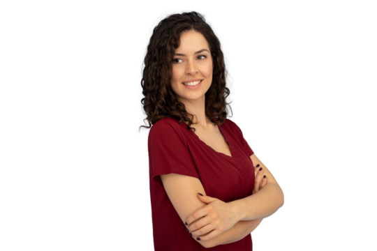 Confident young woman with curly hair, sporting casual shirt, standing with crossed arms, radiating positive energy against clean background - Powered by Adobe