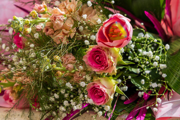 Close-up of flower arrangement with roses and tulips.
