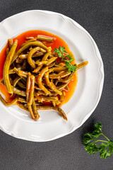 Green beans tomato sauce fresh delicious gourmet food background on the table rustic food top view copy space keto and paleo diet vegetarian and vegan food