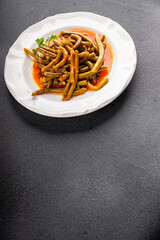 Green beans tomato sauce fresh delicious gourmet food background on the table rustic food top view copy space keto and paleo diet vegetarian and vegan food