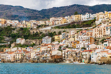 Naklejka premium Italy, Calabria, Scilla. Houses built on the cliff side above the sea.