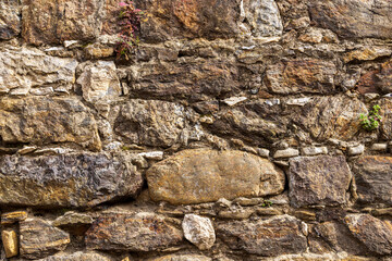 Close-up of weathered stone and concrete wall.