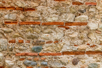 Old wall of brick, stone, and mortar. Italy, Calabria, Cosenza.