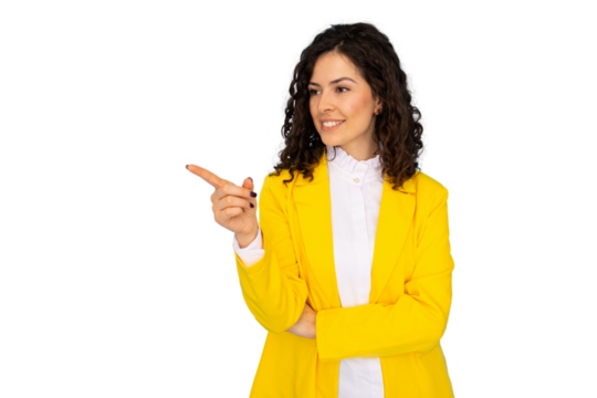 Young manager in yellow jacket pointing left, smiling confidently during professional studio photoshoot