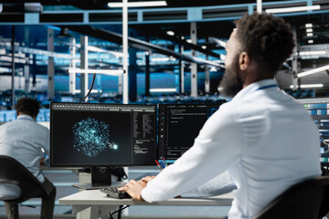 Server farm employee using AI algorithms categorizing and clustering unstructured data. Data center...