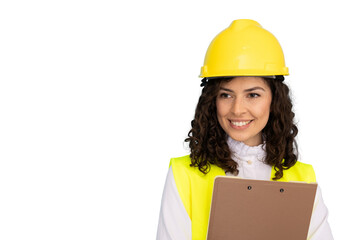 Professional female engineer wearing hard hat, safety vest, smiling while holding clipboard against isolated white background