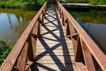Beautiful wooden footbridge across a pond