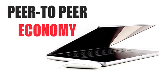 Peer-to-peer economy text with partially closed laptop and wireless mouse on white background