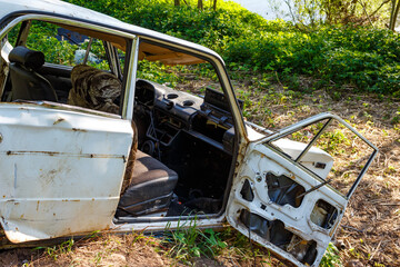 Abandoned and mangled body of a Russian-made car