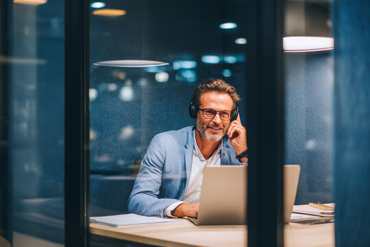 Focused businessman working in office pod