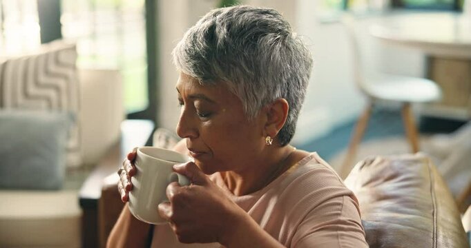 Home, drinking coffee and senior woman relax for peace, calm and thinking in retirement. Living room, tea cup and elderly person with hot beverage, latte and blow steam with espresso for aroma