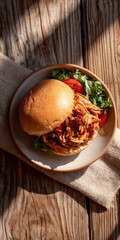 Delicious Pulled Chicken Sandwich with Fresh Vegetables on Rustic Wooden Table