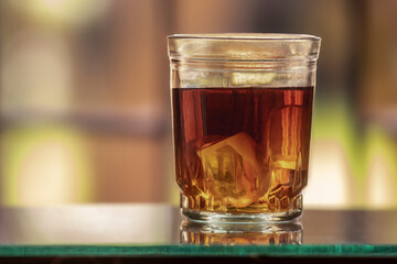 glass of tea on the table with bokeh background