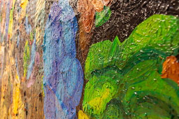 A close-up view of a vibrant and expressive painting created with the help of clippings