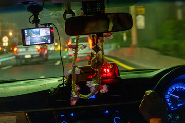 View through the windshield of a taxi car driving in the night city