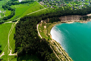Flight over a flooded sand quarry with steep banks