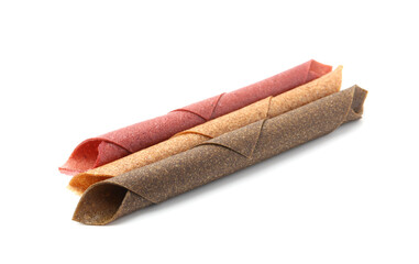 Delicious fruit leather rolls on white background