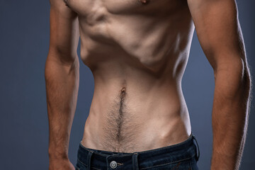 Fototapeta premium Man suffering from anorexia on grey background, closeup