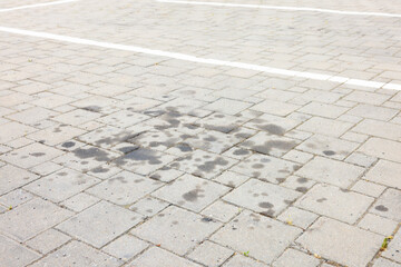 Stains of motor oil on road outdoors, closeup