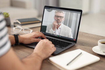 Man having video chat with psychologist via laptop at home, closeup. Online counselling