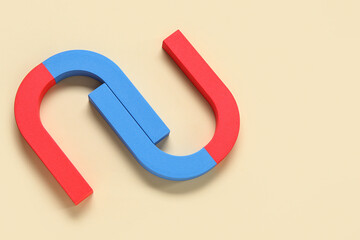 Horseshoe shaped magnets on beige background