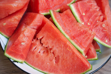 watermelon slices,fresh and organic,on white plate,wood pattern background,