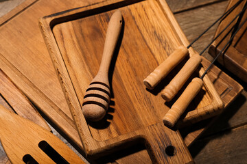 Different cutting boards and dipper on wooden background