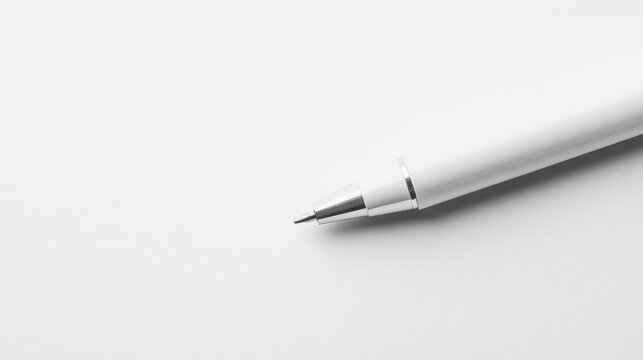 Close-up of a white mechanical pencil on white paper.