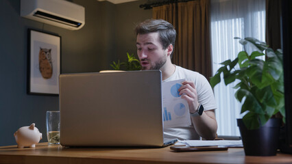 Man presenting charts during video conference
