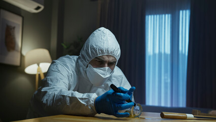 Forensic expert inspecting evidence with flashlight