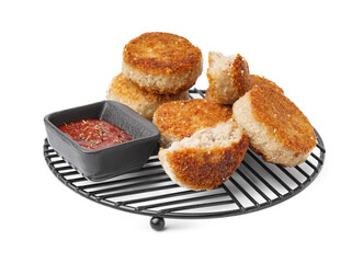 Grid of tasty meat cutlets with sauce on white background