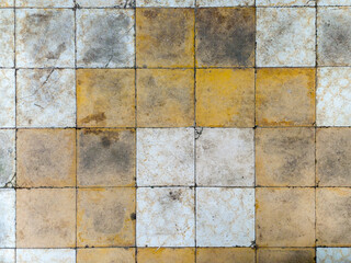 Vibrant mosaic tiles with colorful square tiles in grunge tones. Old antique stone pattern and rough texture, ideal for abstract backgrounds and design projects.