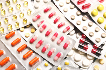 Blister packs with different pills as background