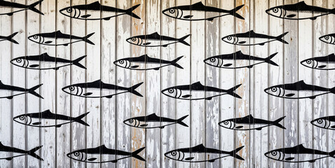  Repetitive fish stencil artwork on rustic wooden planks in a coastal theme.