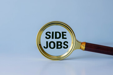 Side Jobs text message and magnifying glass with space copy on wooden background.