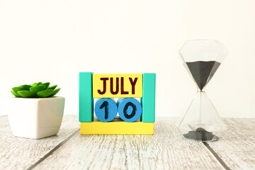 Vintage photo, July 10th. Date of 10 July on wooden cube calendar