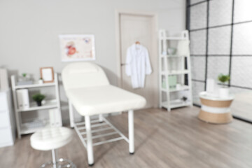 Blurred view of medical office with couch and door