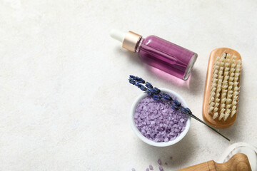 Fototapeta na wymiar Beautiful composition with bottle of lavender oil, brush and sea salt in bowl on light background, closeup